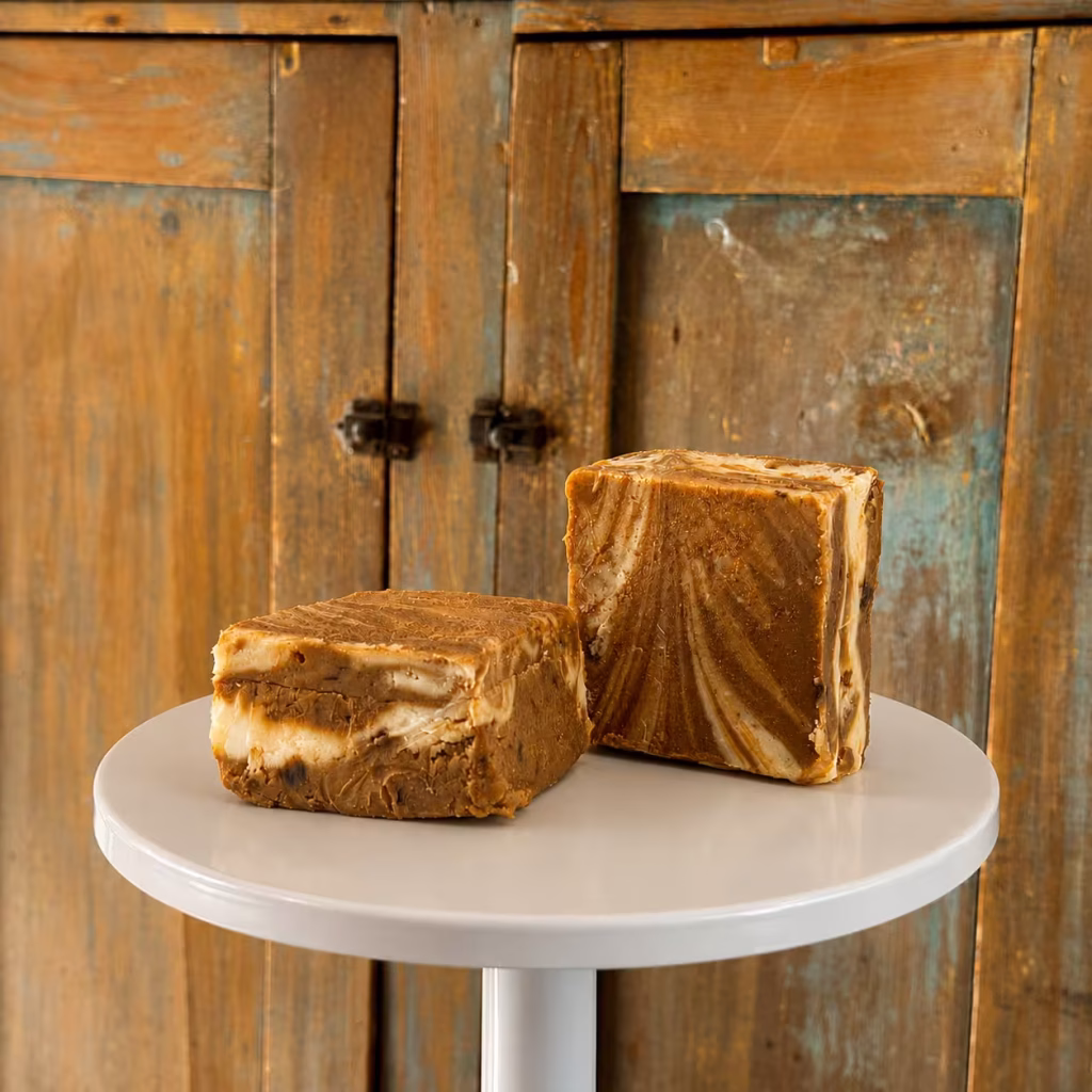 two pieces of Cappaccino Goat Milk Chocolate Fudge on a cake stand