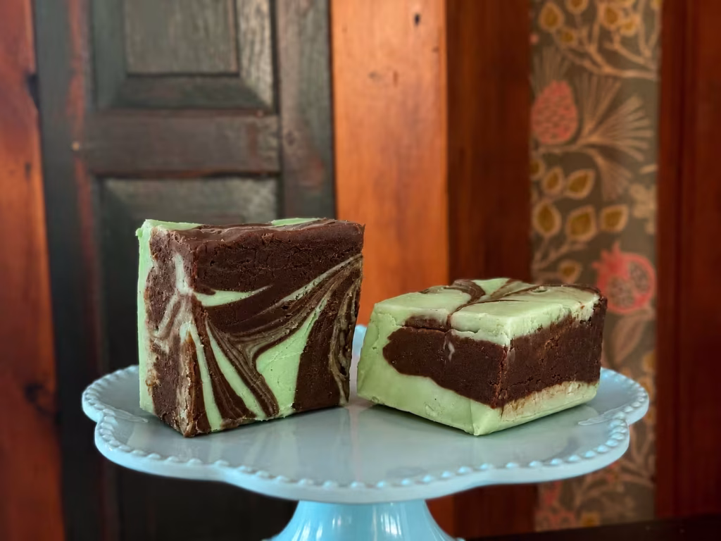 goat milk chocolate swirl fudge on a cake stand