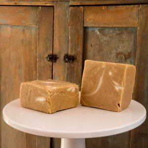 two pieces of Hazelnut Coffee Goat Milk Fudge on a pedestal